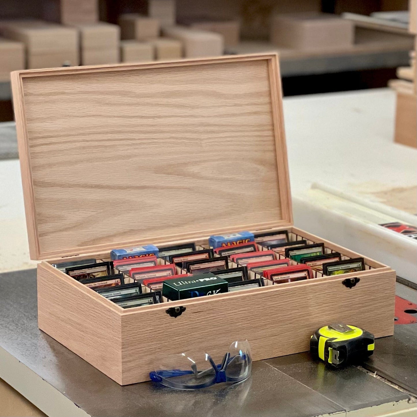 https://www.thedesigncraftstudio.com/cdn/shop/products/the-designcraft-studio-game-card-boxes-wooden-trading-card-deck-box-includes-20-removable-dividers-fits-up-to-1875-sleeved-cards-handmade-box-shown-in-oak-36240588570785.jpg?v=1671835848&width=1445